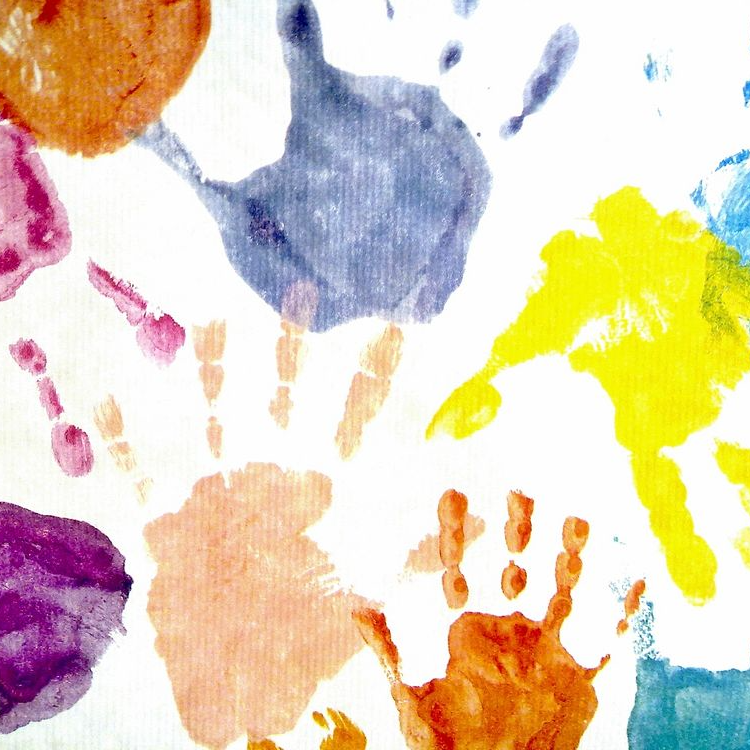 Illustration of colorful children's handprints.